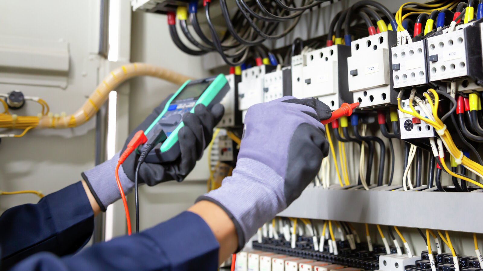 Electrical engineer tests electrical installations and wiring on relay protection system. Adjustment of form for automation and control of electrical equipment.