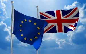 Flags of EU and UK floating in the sky