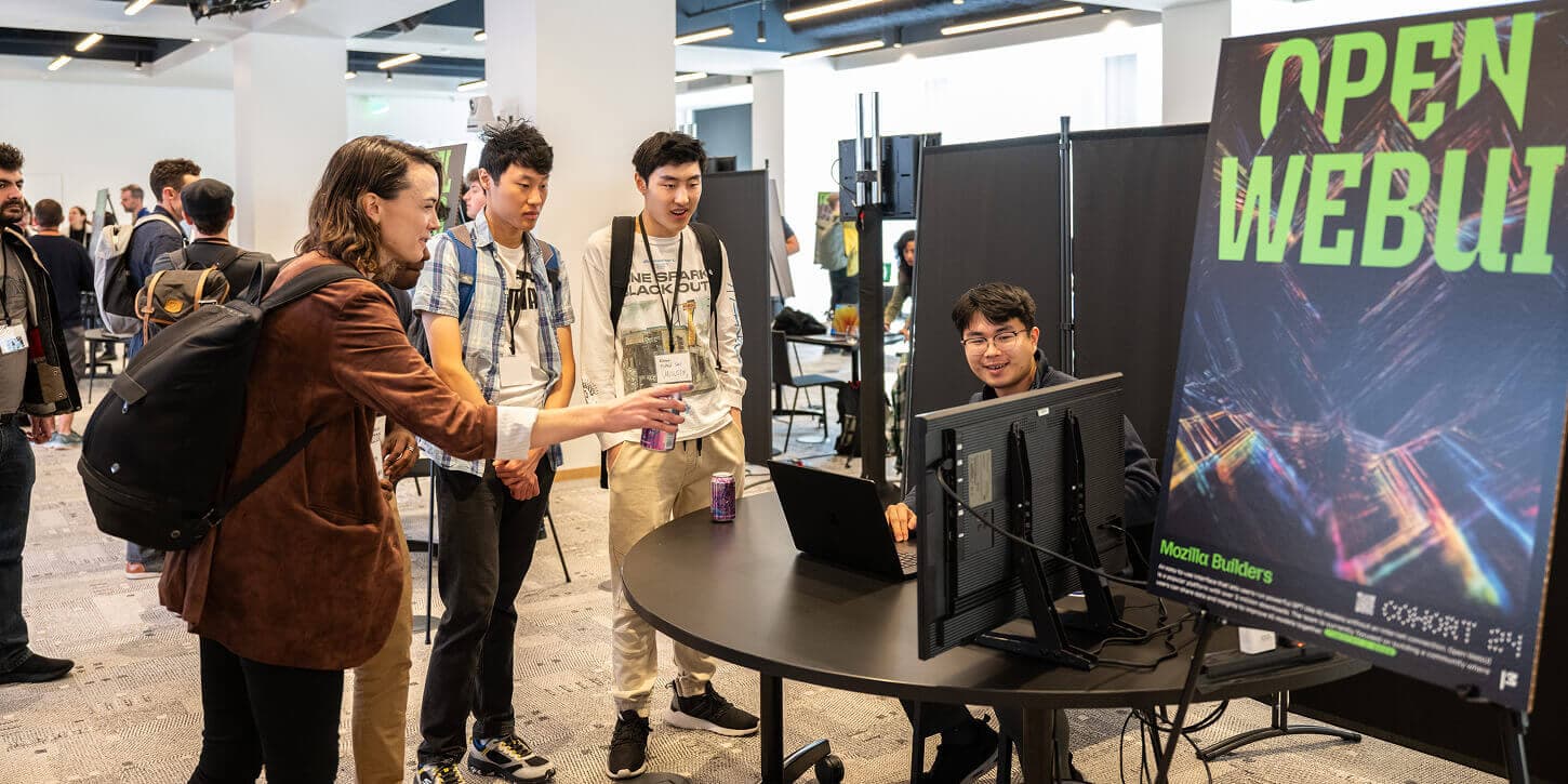Tim Jaeryang Baek shows a demo of Open WebUI to several attendees of Mozilla Builders Demo Day.