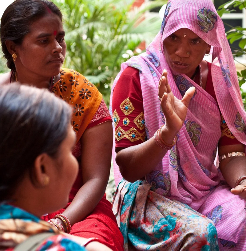 A photograph of south asian women holding a serious conversation